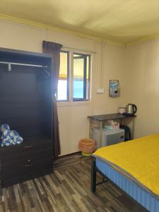 a bedroom with a bed and a window at Permata Beach Chalet in Kampong Juara