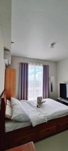 a bedroom with a large bed with a window at Jack Cabin in Lapu Lapu City +25 photos