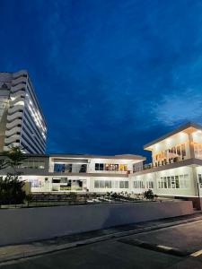 a large white building with a tall building at Jack Cabin in Lapu Lapu City