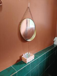 a mirror hanging above a counter in a bathroom at Permata Beach Chalet in Kampong Juara