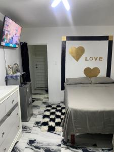 a bedroom with a bed with hearts on the wall at White Room Sparks in Spanish Town