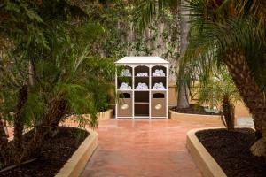 a white cabinet with palm trees in a courtyard at Hollywood Hotel in Los Angeles