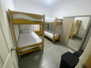 a small room with two bunk beds and a mirror at Departamento Sol y Mar in Caleta Grau +29 photos