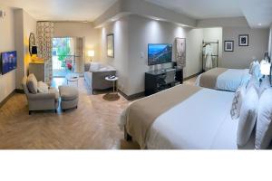 a bedroom with a large bed and a living room at Hollywood Hotel in Los Angeles
