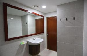 a bathroom with a sink and a mirror at Hotel Orkid Hills at Kuala Lumpur in Kuala Lumpur +35 photos