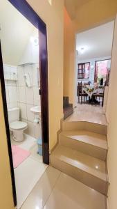 a bathroom with a staircase leading to a toilet at Hospedagem Casa Da Lia in Lençóis