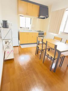 a kitchen and dining room with a table and chairs at inn 2nd in Kurashiki
