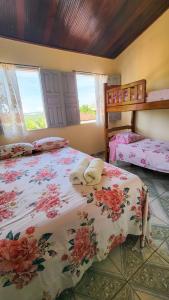 a bedroom with two beds and a window at Hospedagem Casa Da Lia in Lençóis