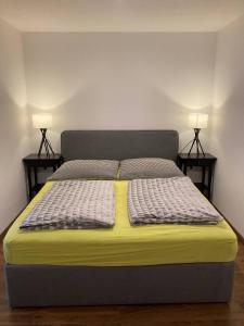 a bed in a room with two lamps on both sides at Wunderschön gelegene Ferienwohnungen im Zentrum von Zell an der Mosel in Zell an der Mosel