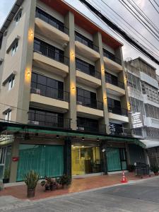an apartment building with balconies and a street at Money Home in Bangkok