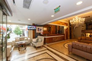 a lobby with a waiting room with a chandelier at Crestium Prime Square in Istanbul