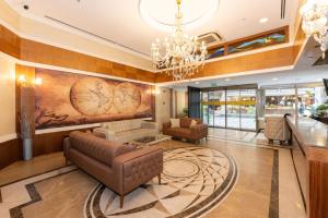 a living room with a couch and a chandelier at Aven Hotel in Istanbul