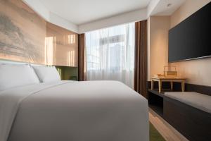 Voodi või voodid majutusasutuse JINGCADIA Hotel Nanjing Confucius Temple toas