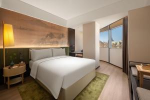 Voodi või voodid majutusasutuse JINGCADIA Hotel Nanjing Confucius Temple toas