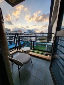 a balcony with a table and a chair on a building at Modern Chic in Hengchun
