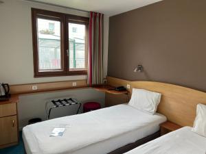 Postel nebo postele na pokoji v ubytování Kyriad Montpellier Aéroport - Parc Expo