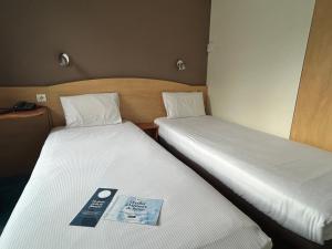 Postel nebo postele na pokoji v ubytování Kyriad Montpellier Aéroport - Parc Expo