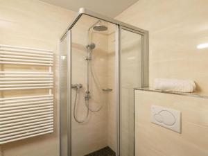 a shower with a glass door in a bathroom at Apartment in Fügen near Spieljoch Ski Lift in Fügen