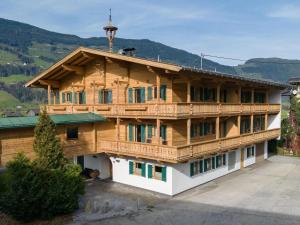 a large wooden house with a balcony at Apartment in Fügen near Spieljoch Ski Lift in Fügen