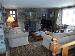 a living room with two couches and a fireplace at Gages Mill in Ashburton