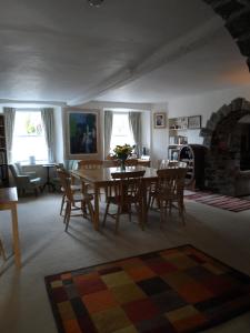 a living room with a table and chairs and a fireplace at Gages Mill in Ashburton