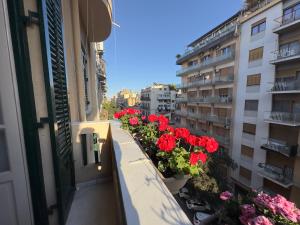 a balcony with flowers on the side of a building at L'Angolo di Palermo in Palermo +52 photos
