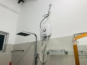 a shower in a bathroom with a shower head at Villa33 in Weligama +45 photos