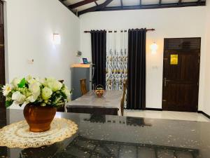 a room with a vase of flowers on a table at Villa33 in Weligama