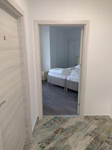 a bedroom with a bed and a door with a mirror at Мотел "Релакс" Motel "Relax", Балчик, in Balchik