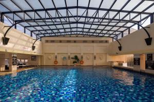a large swimming pool with a glass ceiling at Sheraton Chengdu Lido Hotel in Chengdu