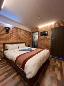 Postel nebo postele na pokoji v ubytování Hotel Durbar Side
