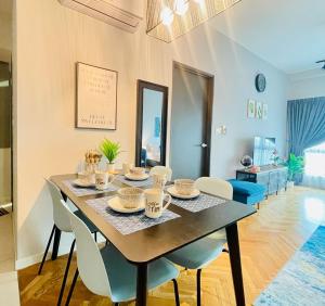 a dining room with a table and chairs at Emira Residence by AisyieraLodgestay in Shah Alam