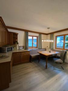 a kitchen with a couch and a table in a room at Ferienwohnung Achhorner in Kössen