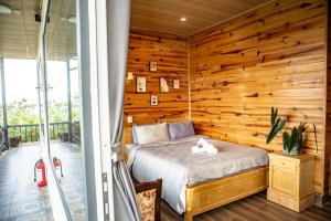 Un dormitorio con una pared de madera y una cama en Kinda Blue Room, en Xuan An 13 fotos más