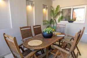 a dining room with a wooden table and chairs at Diantha in Lixouri