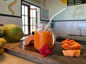 a jar of orange juice on a wooden cutting board at Kitekuda Kite Resort in Vannativillu