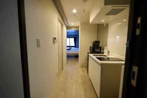 a kitchen with a sink and a counter top at OPUS Haneda in Tokyo