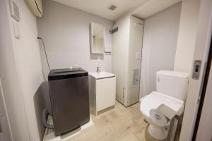 a small bathroom with a toilet and a sink at OPUS Haneda in Tokyo +29 photos
