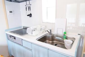 a small kitchen with a sink and a counter top at Bath in Beppu +40 photos