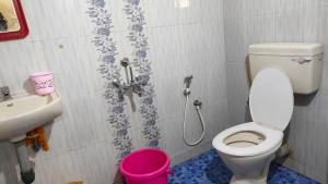 a bathroom with a toilet and a sink at Christa Homestay in Mangalore +9 photos