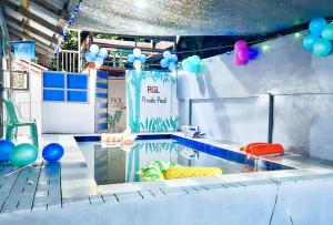 a swimming pool with balloons and a party at RGL Condotel Socorro by RedDoorz in Casiligan