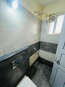 a bathroom with a toilet and a shower at REGAL SUITES in Trivandrum