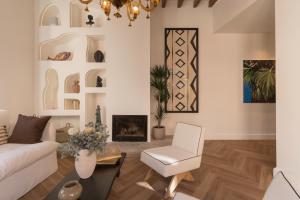 a living room with a white couch and a fireplace at Es Petit de Valldemossa in Valldemossa