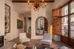 a living room with two chairs and a chandelier at Es Petit de Valldemossa in Valldemossa