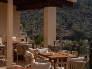 a balcony with tables and chairs and a view at Es Petit de Valldemossa in Valldemossa