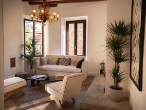 a living room with a couch and a table at Es Petit de Valldemossa in Valldemossa