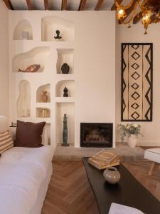 a living room with a bed and a fireplace at Es Petit de Valldemossa in Valldemossa