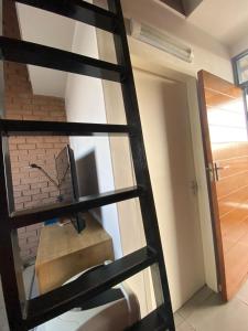 a ladder with a tv in a room at Mordern Lil' Love Nest Loft in Midrand in Midrand