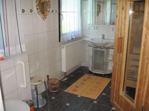 une salle de bain avec un lavabo et des toilettes dans l'établissement Ferienhaus Nr 74, Kategorie Komfort L m Sauna, behindertenfreundlich, Feriendorf Hochbergle, Allgäu, à Bichel 7 autres photos