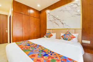 a bedroom with a bed and a map on the wall at FabHotel Blooming Beds Pearl in Jaipur +33 photos